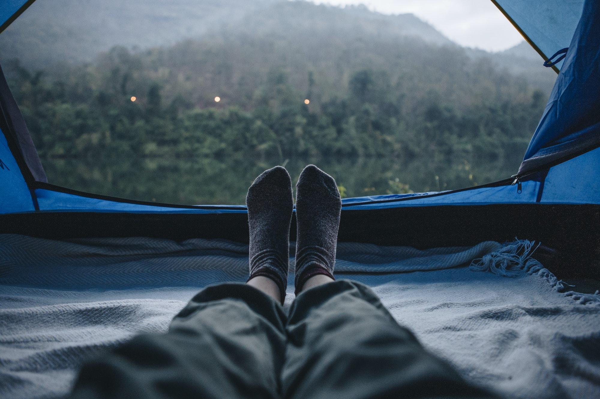 Woman sleeping in a tent with an amazing view
